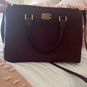 Used Michael Kors bag Burgundy.  Has shoulder strap and handles.